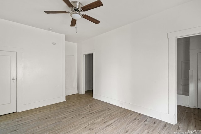 unfurnished room featuring light wood-type flooring and ceiling fan