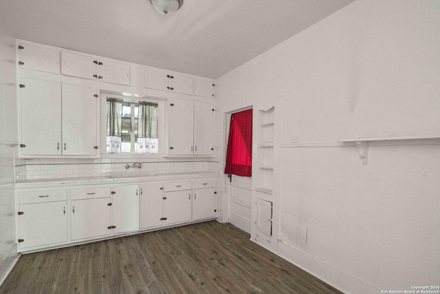 bathroom featuring hardwood / wood-style flooring and decorative backsplash