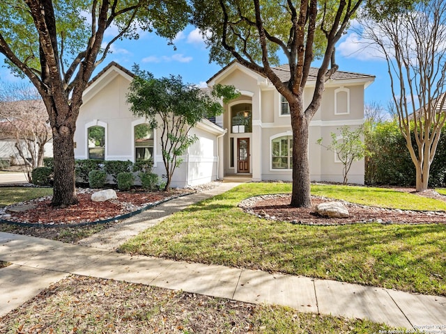 mediterranean / spanish-style home featuring a front yard