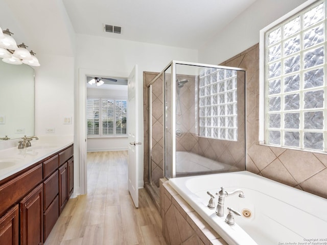 bathroom featuring vanity, hardwood / wood-style floors, and shower with separate bathtub