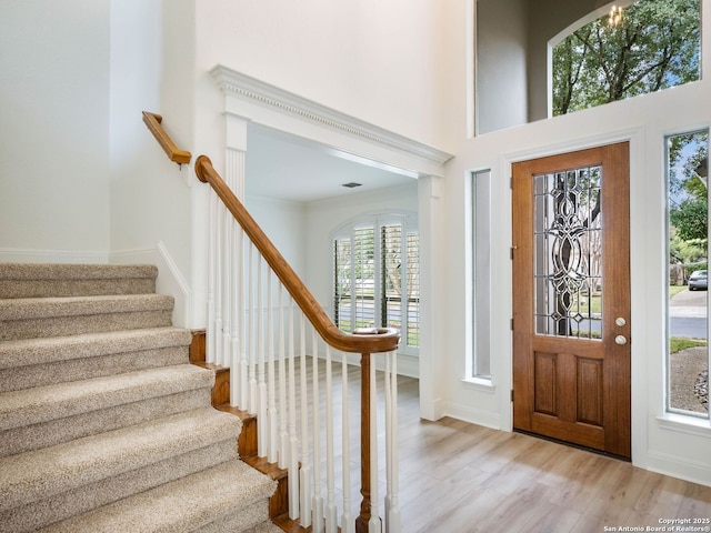 entrance foyer featuring light wood-type flooring and a high ceiling