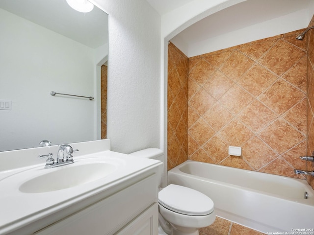 full bathroom with toilet, vanity, and tiled shower / bath