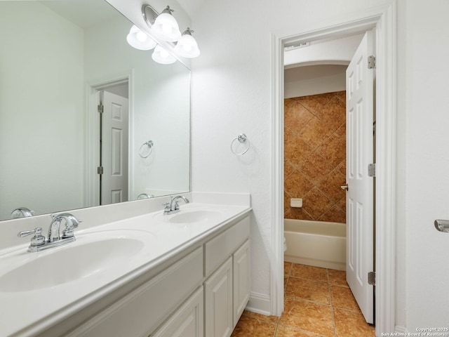 full bathroom with toilet, tile patterned flooring, vanity, and tiled shower / bath