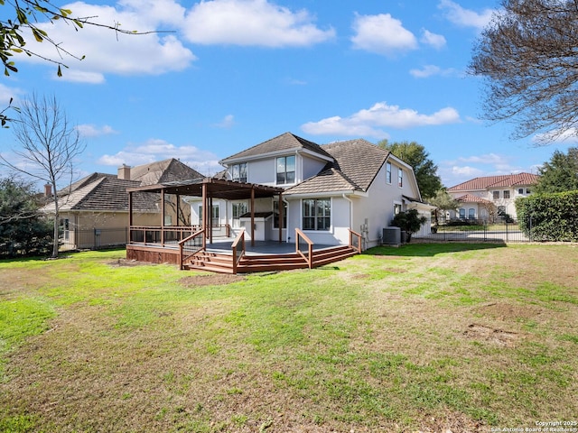 back of property with central air condition unit, a wooden deck, and a lawn