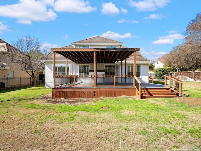 rear view of property featuring a yard and a deck