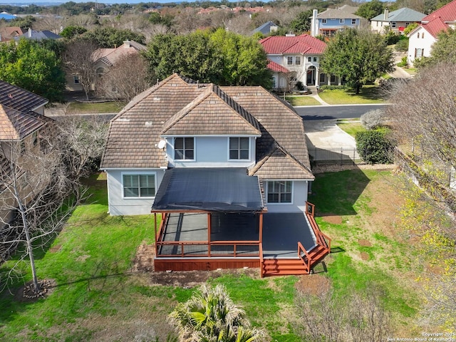 back of house featuring a lawn