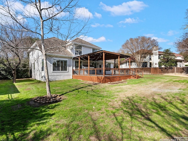 back of house featuring a yard and a deck