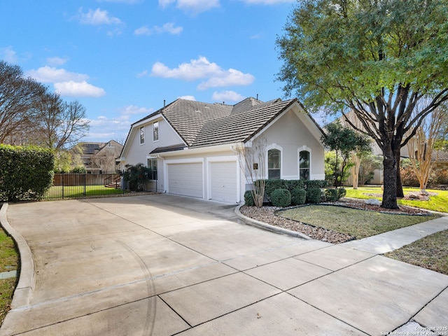 ranch-style home featuring a garage and a front yard