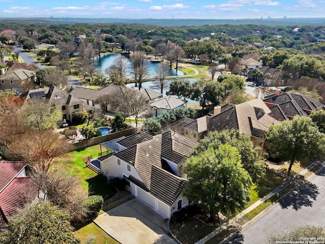 birds eye view of property with a water view