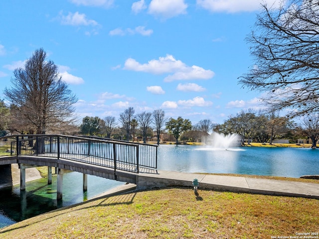 dock area with a water view and a lawn