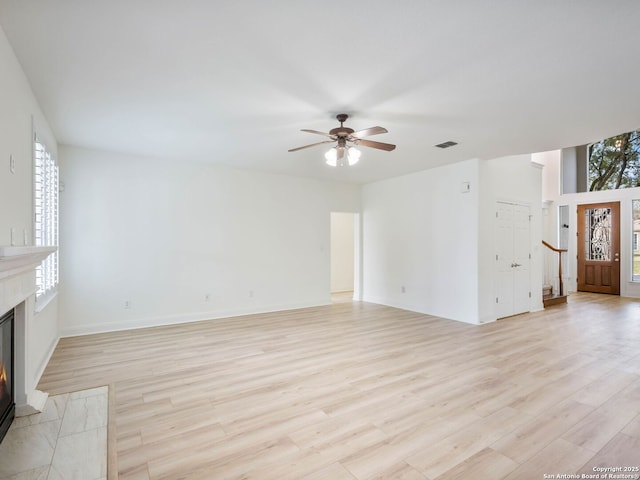 unfurnished living room featuring light hardwood / wood-style flooring and ceiling fan