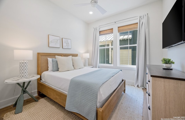 bedroom with ceiling fan and light hardwood / wood-style floors