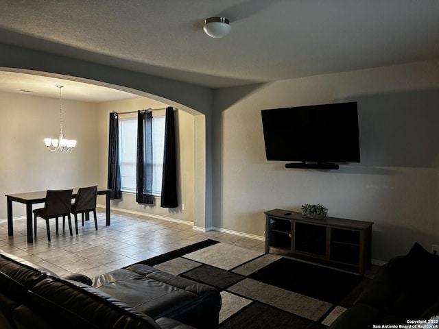 living room featuring light tile patterned floors and a chandelier