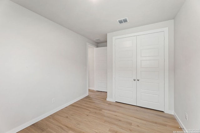 125 Connor Crk, San Antonio, TX 78253 - unfurnished bedroom featuring light wood finished floors, baseboards, and a closet