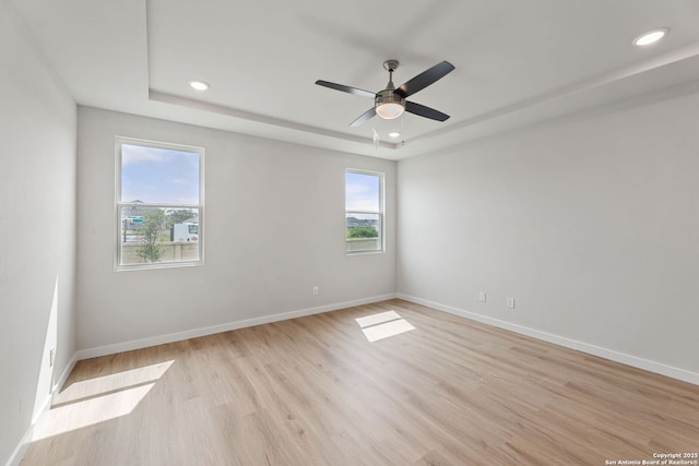 125 Connor Crk, San Antonio, TX 78253 - spare room with plenty of natural light, recessed lighting, a tray ceiling, and light wood finished floors
