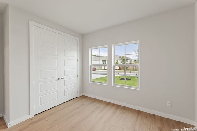 125 Connor Crk, San Antonio, TX 78253 - unfurnished bedroom with light wood-type flooring, baseboards, and a closet