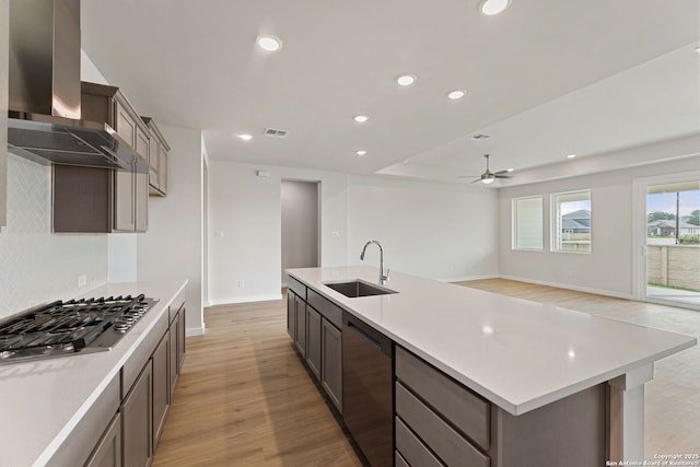 125 Connor Crk, San Antonio, TX 78253 - kitchen with appliances with stainless steel finishes, a sink, a ceiling fan, wall chimney range hood, and recessed lighting