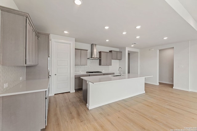 125 Connor Crk, San Antonio, TX 78253 - kitchen featuring wall chimney exhaust hood, a sink, gray cabinets, light wood finished floors, and recessed lighting