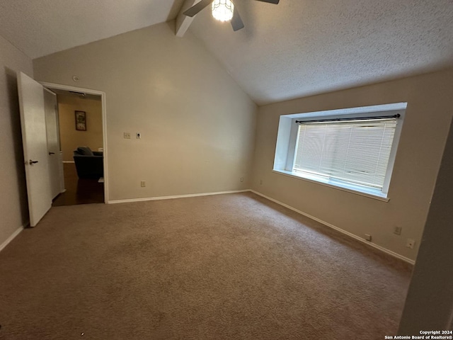 unfurnished room with a textured ceiling, ceiling fan, carpet flooring, and lofted ceiling with beams