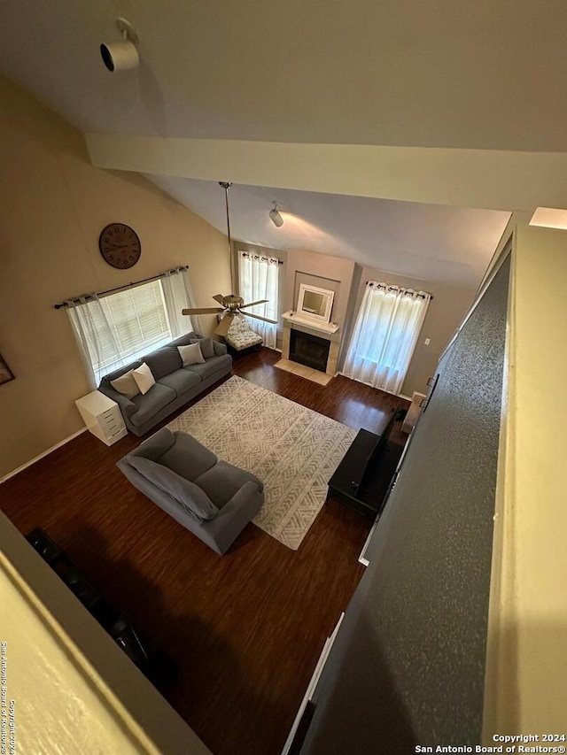 living room with ceiling fan, vaulted ceiling, and dark hardwood / wood-style flooring