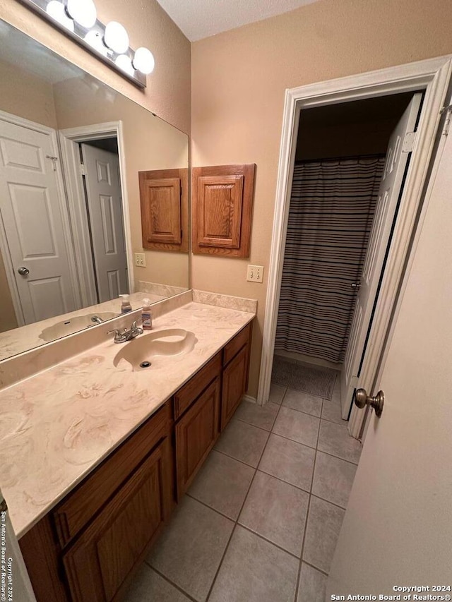 bathroom featuring tile patterned flooring and vanity