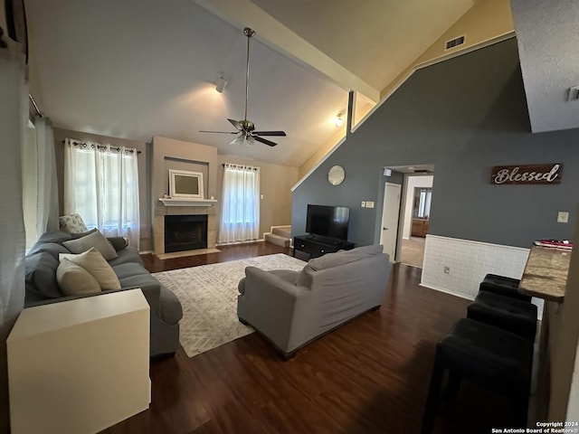 living room featuring a tile fireplace, ceiling fan, high vaulted ceiling, and dark hardwood / wood-style flooring