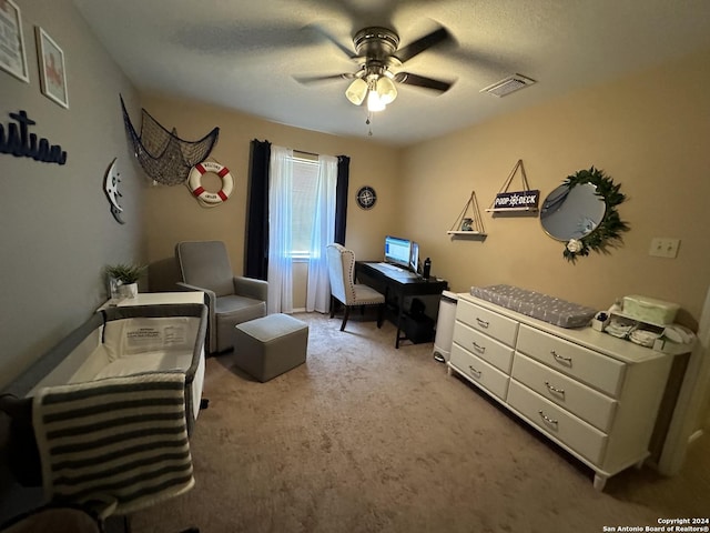 carpeted office featuring ceiling fan