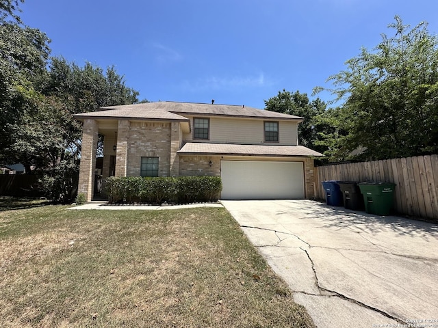 view of front of property with a front yard and a garage