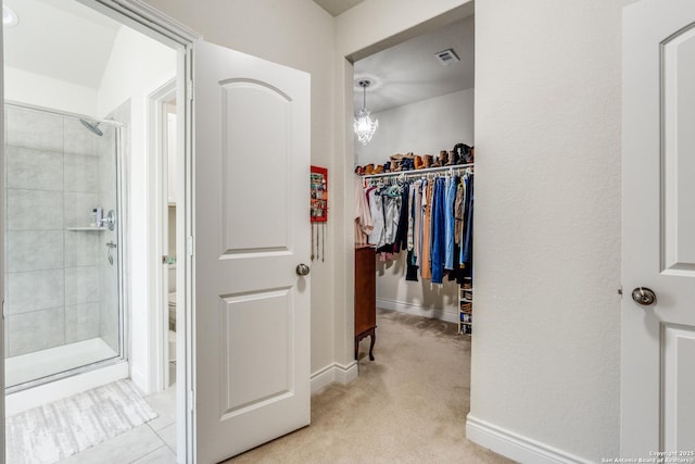 walk in closet featuring light carpet