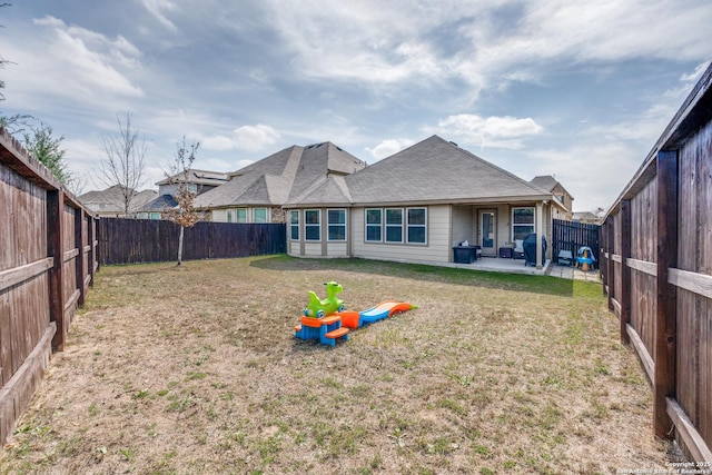 back of house featuring a yard and a patio area