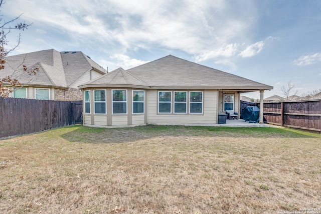 back of property featuring a yard and a patio area