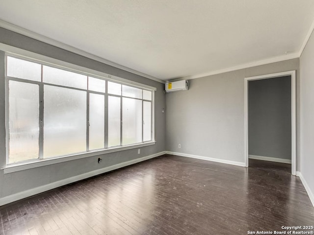 unfurnished room featuring dark hardwood / wood-style flooring, a wall unit AC, and crown molding