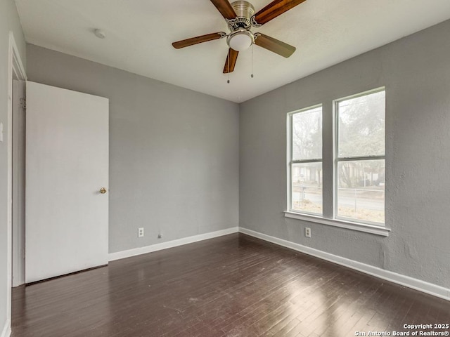 unfurnished room with dark hardwood / wood-style floors and ceiling fan