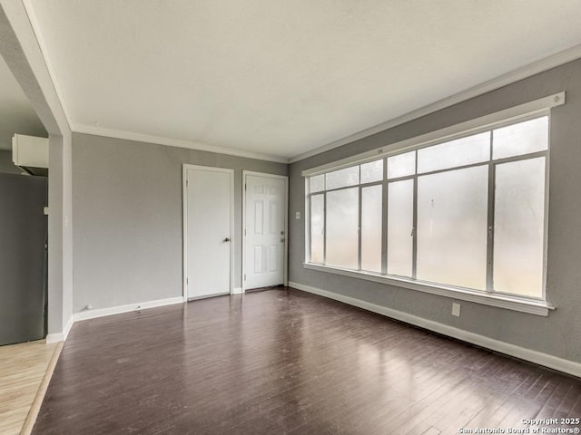 unfurnished room with hardwood / wood-style flooring, plenty of natural light, and ornamental molding