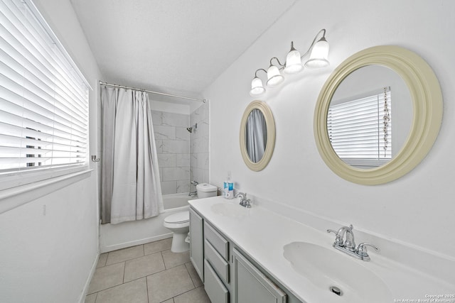 full bathroom with tile patterned flooring, toilet, a textured ceiling, shower / tub combo with curtain, and vanity