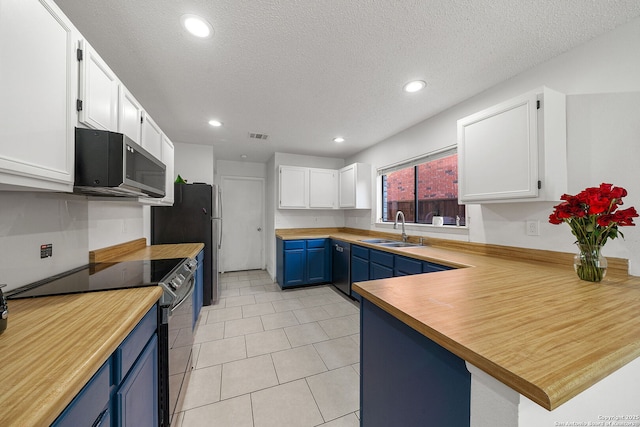 kitchen with sink, white cabinets, stainless steel appliances, and blue cabinets