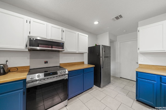 kitchen with white cabinetry, blue cabinetry, stainless steel appliances, and a textured ceiling