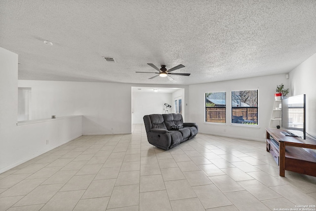 tiled living room featuring a textured ceiling and ceiling fan