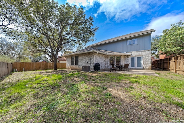 rear view of house featuring a yard, a patio, french doors, and central AC