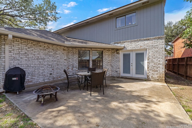 view of patio / terrace with a grill, french doors, and a fire pit