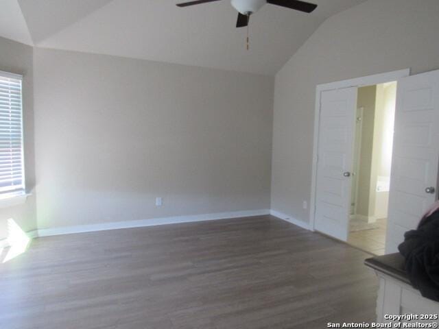 spare room featuring ceiling fan, lofted ceiling, and dark hardwood / wood-style flooring