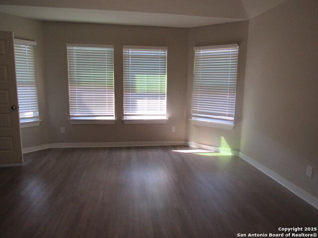 unfurnished room with dark hardwood / wood-style floors