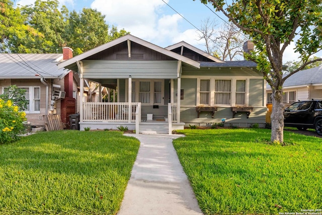 bungalow-style house with a front yard and a porch