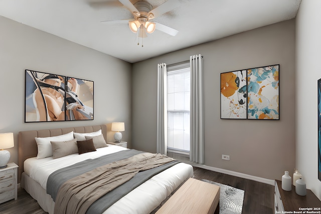 bedroom with ceiling fan and dark hardwood / wood-style floors