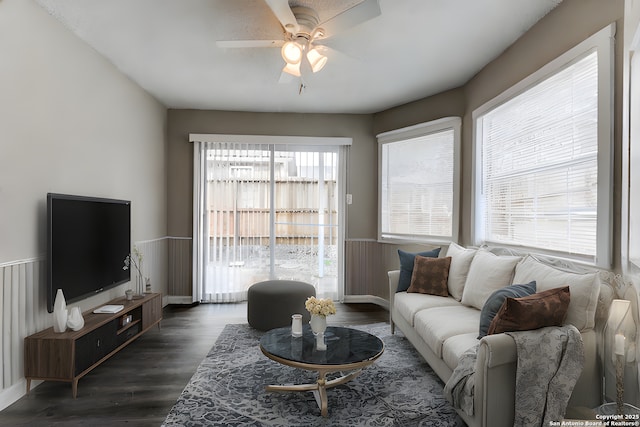 living room featuring dark wood-type flooring and ceiling fan