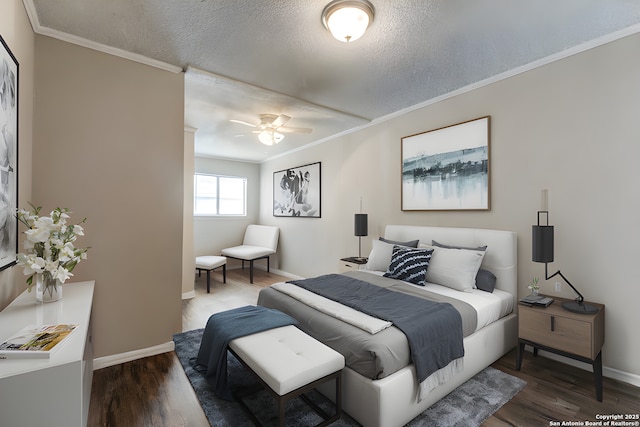 bedroom featuring crown molding, dark hardwood / wood-style flooring, and a textured ceiling