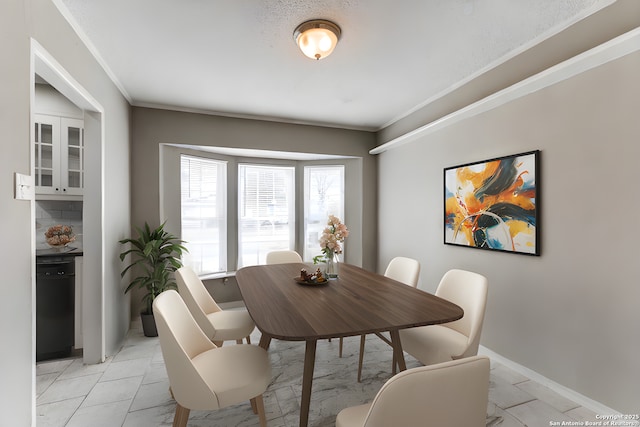 dining area featuring crown molding