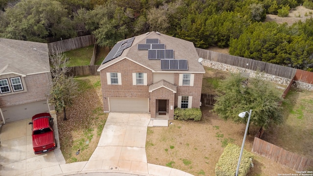 view of front property with a garage and solar panels