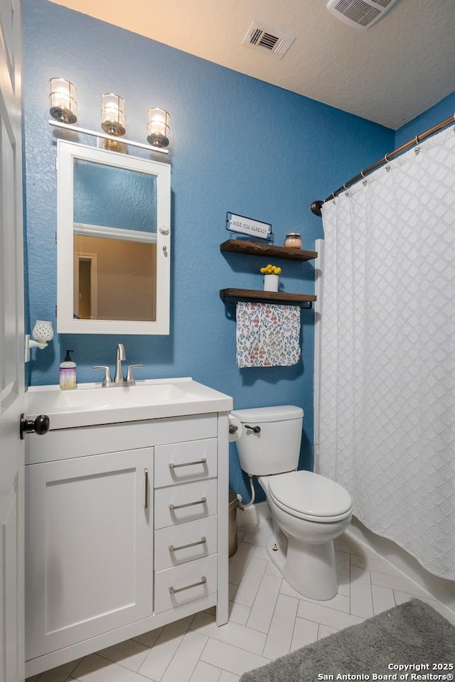 bathroom featuring toilet, a shower with curtain, and vanity