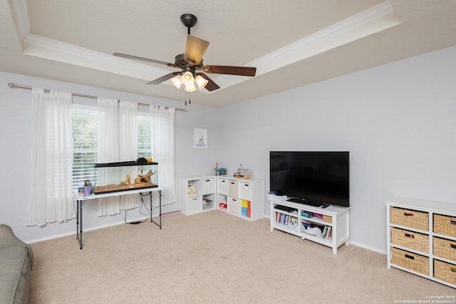 recreation room with a tray ceiling, ceiling fan, carpet floors, and crown molding